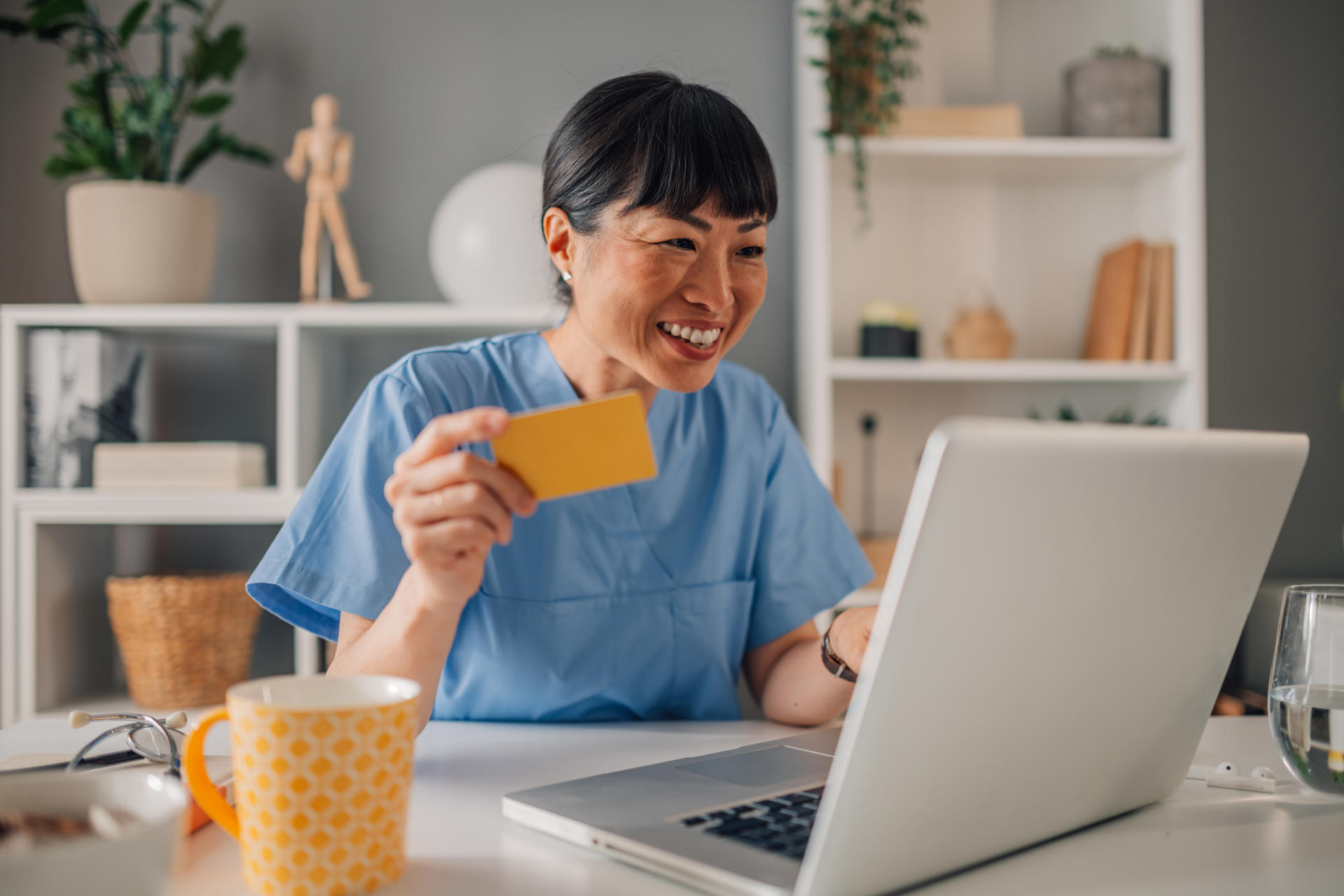 asian female health worker in blue scrubs holding 2025 03 30 22 30 34 utc.jpg